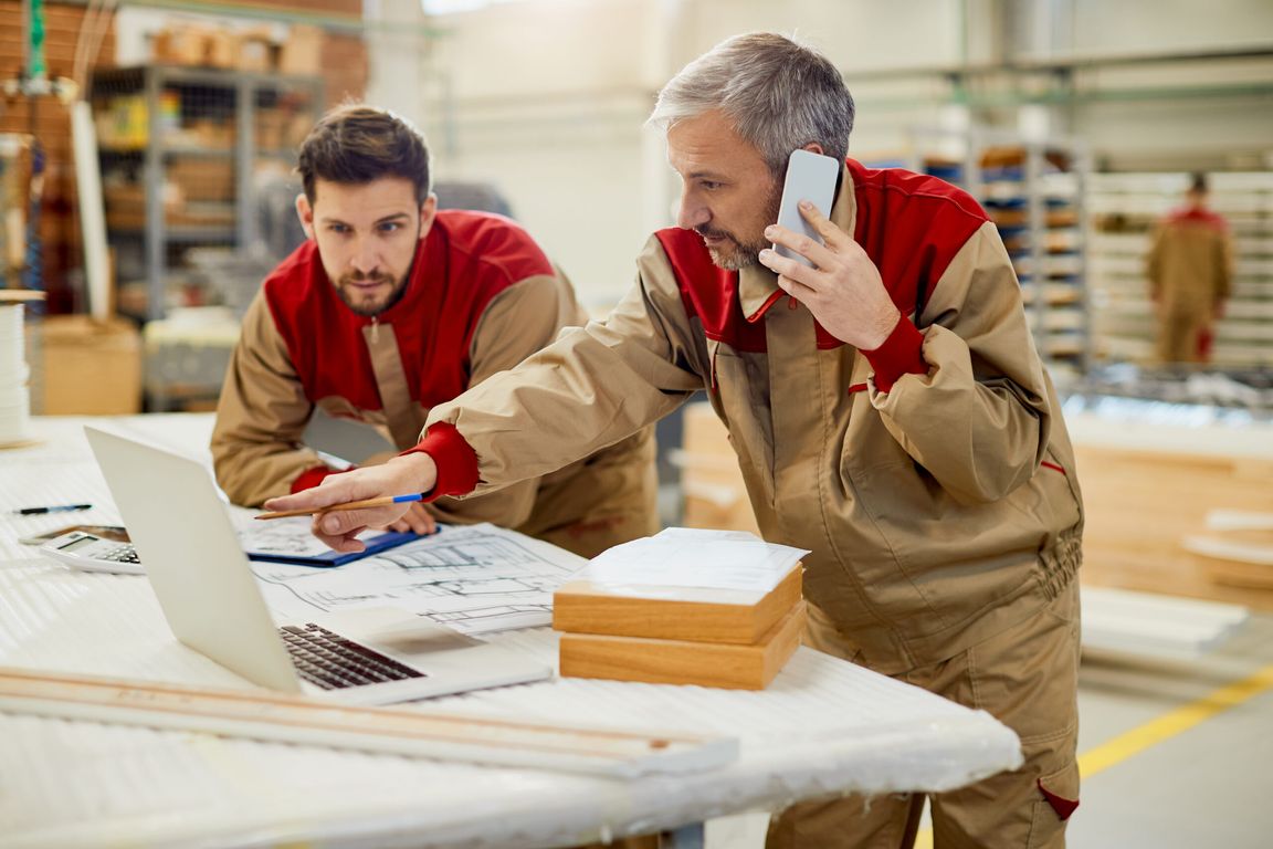 A workshop worker on the phone at a computer
